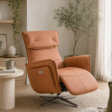 Copenhagen electric recliner chair in living room setting with a small table and plant.
