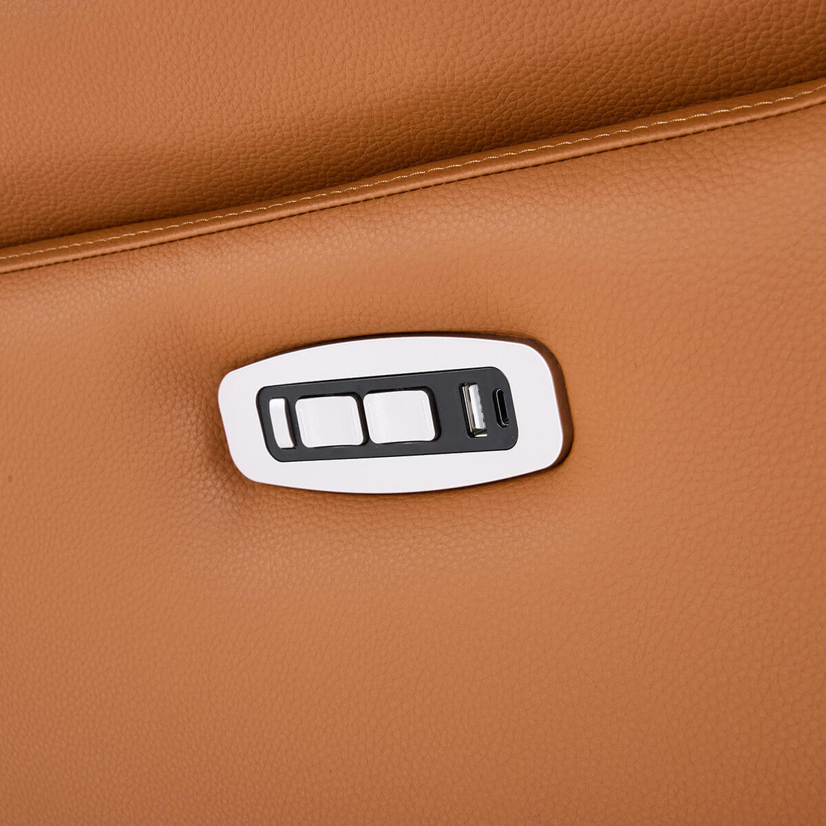 Close-up of a brown leather surface with a USB charging port and power button.