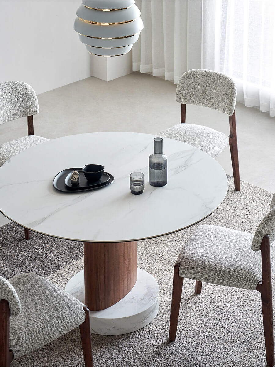 Aalto round dining table styled with upholstered dining chairs