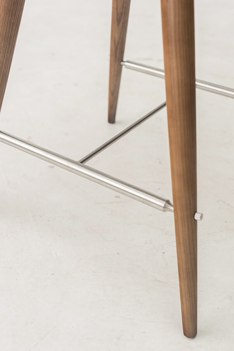Stainless steel footrest and solid ash frame detail on the Andy bar stool