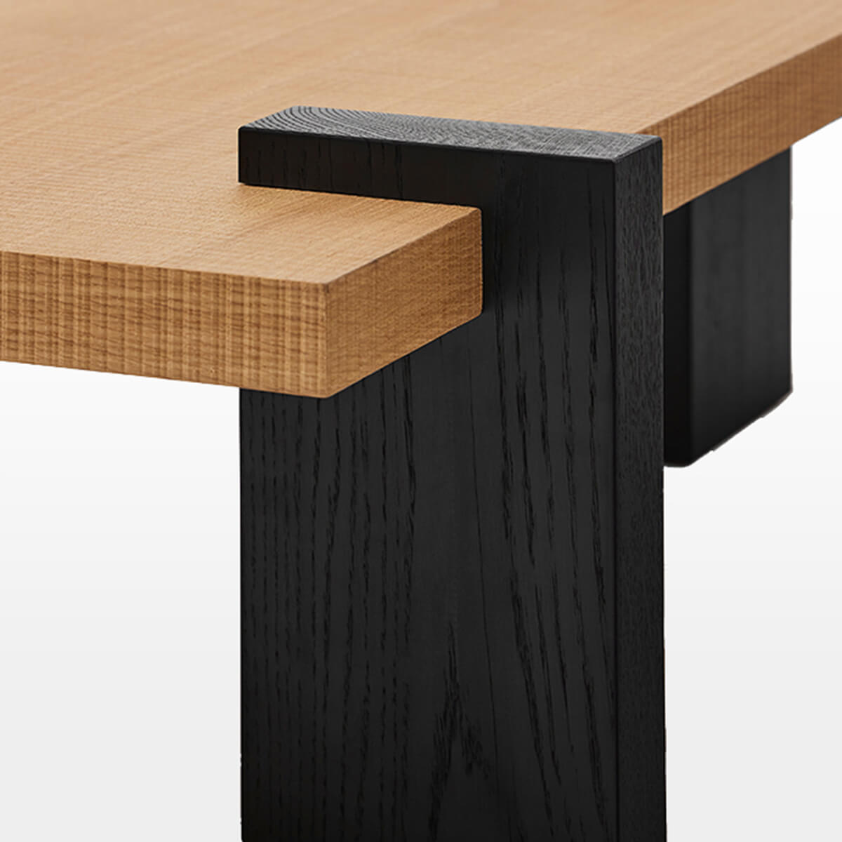 Close-up of Anya Coffee Table wrap-around solid oak leg