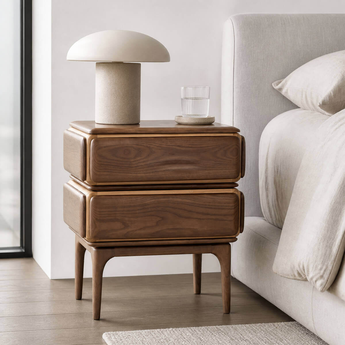 Arnold Solid Walnut Bedside Table beside a bed in a modern bedroom