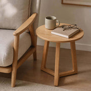 Aspen Solid Oak Side Table beside a lounge chair in a contemporary reading corner