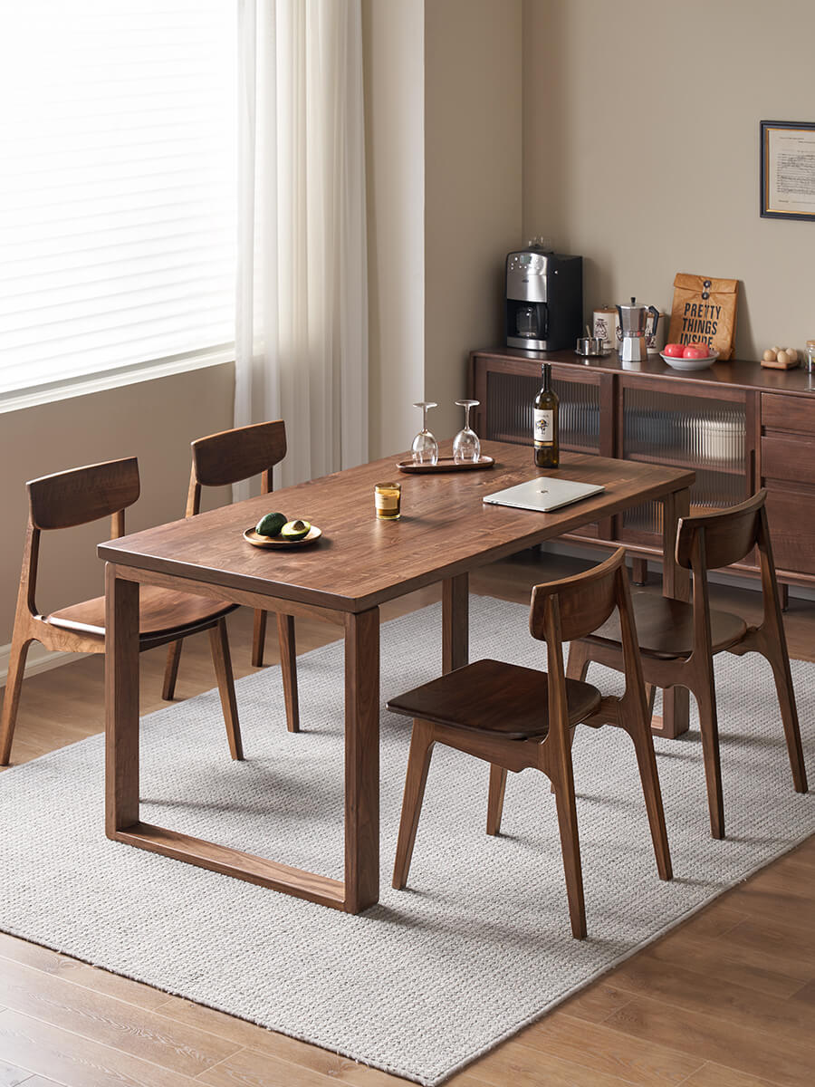 Aster solid walnut dining table styled with dining chairs