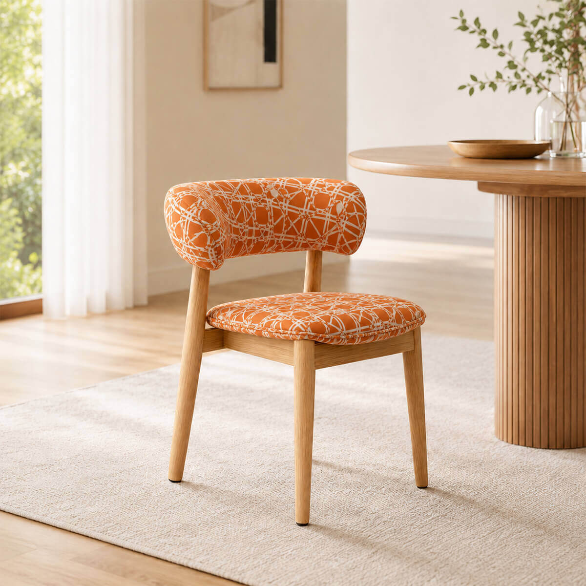 Aurelia dining chair with orange patterned upholstery and solid walnut frame