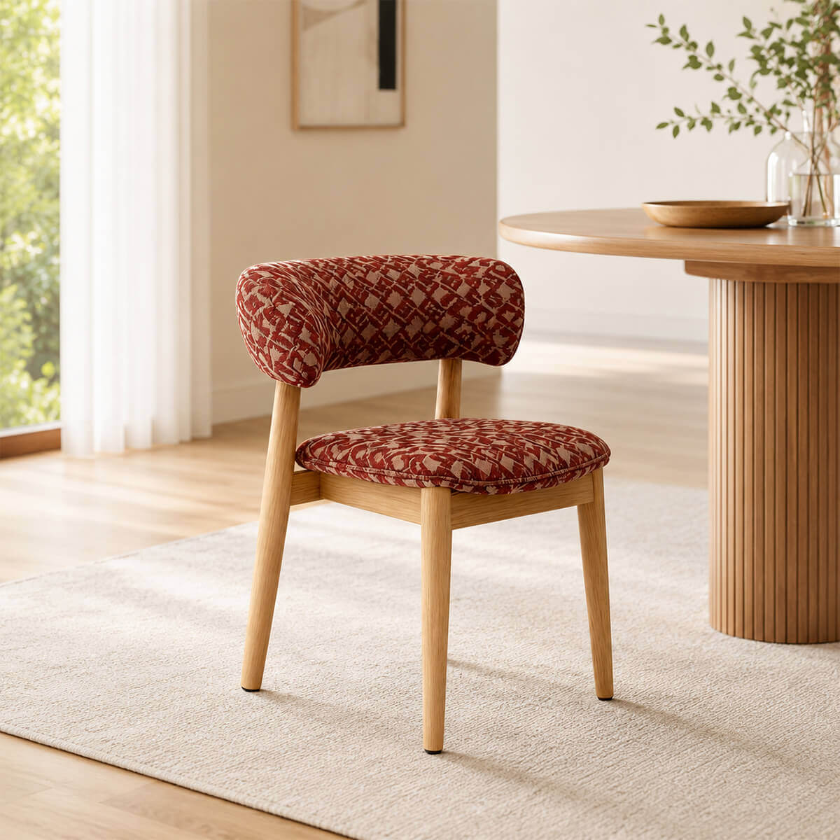 Aurelia dining chair with red patterned upholstery beside a walnut dining table