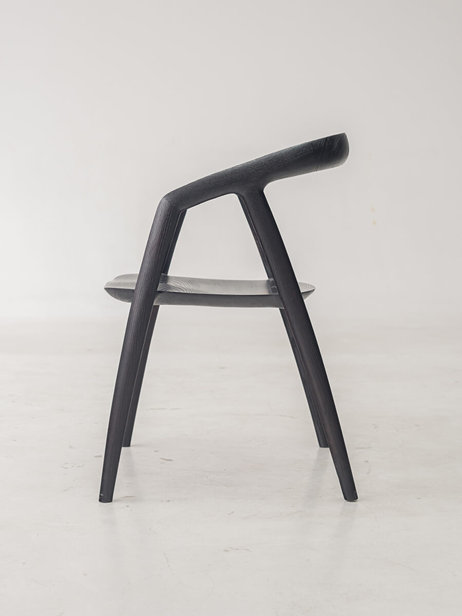 Side view of Bata dining chair in black finish
