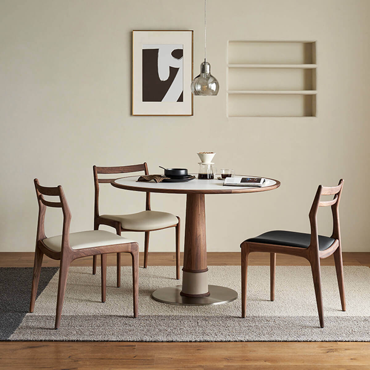 Cambell round dining table with white sintered stone top in a dining setting
