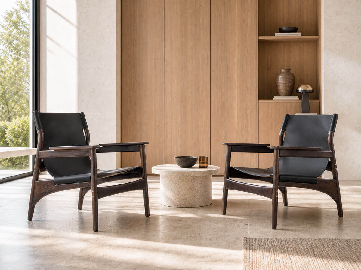 Two Carey armchairs with dark ash timber frames in a modern living room
