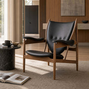 Chieftain chair replica with black leather upholstery in a modern interior