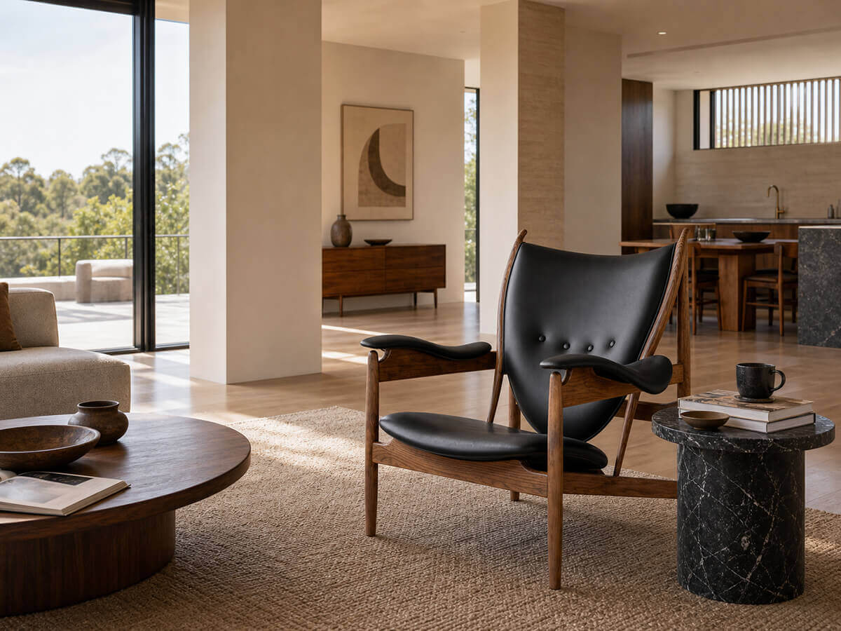Chieftain chair replica with black leather in a contemporary lounge space