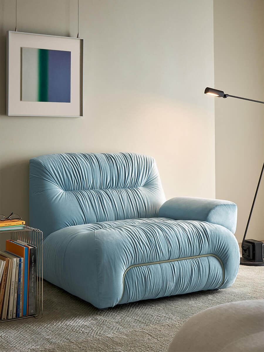 Cloudscape Armchair in blue fabric upholstery styled in a modern lounge area