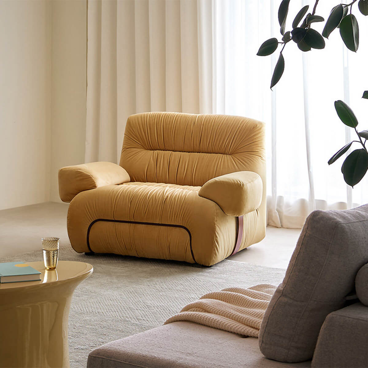 Cloudscape Armchair in mustard fabric upholstery styled in a contemporary living room