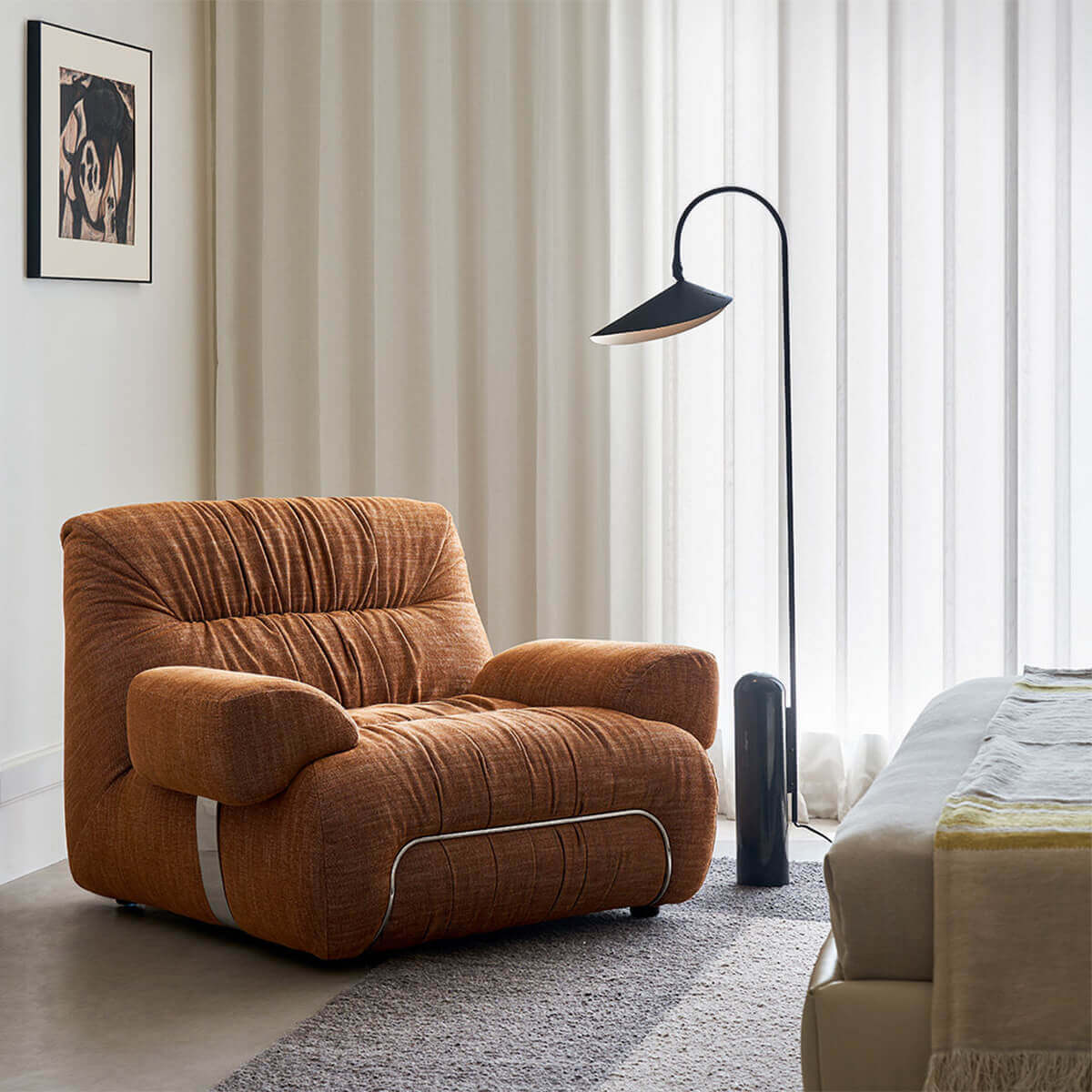 Cloudscape Armchair in rust fabric upholstery styled in a modern bedroom