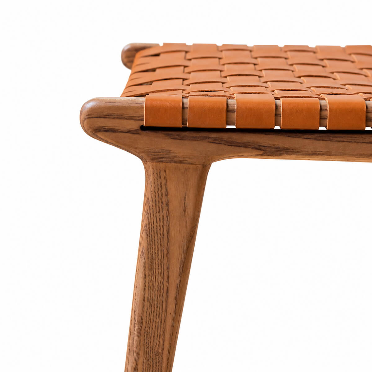 Close-up of Connar dining chair woven saddle leather seat and walnut timber frame