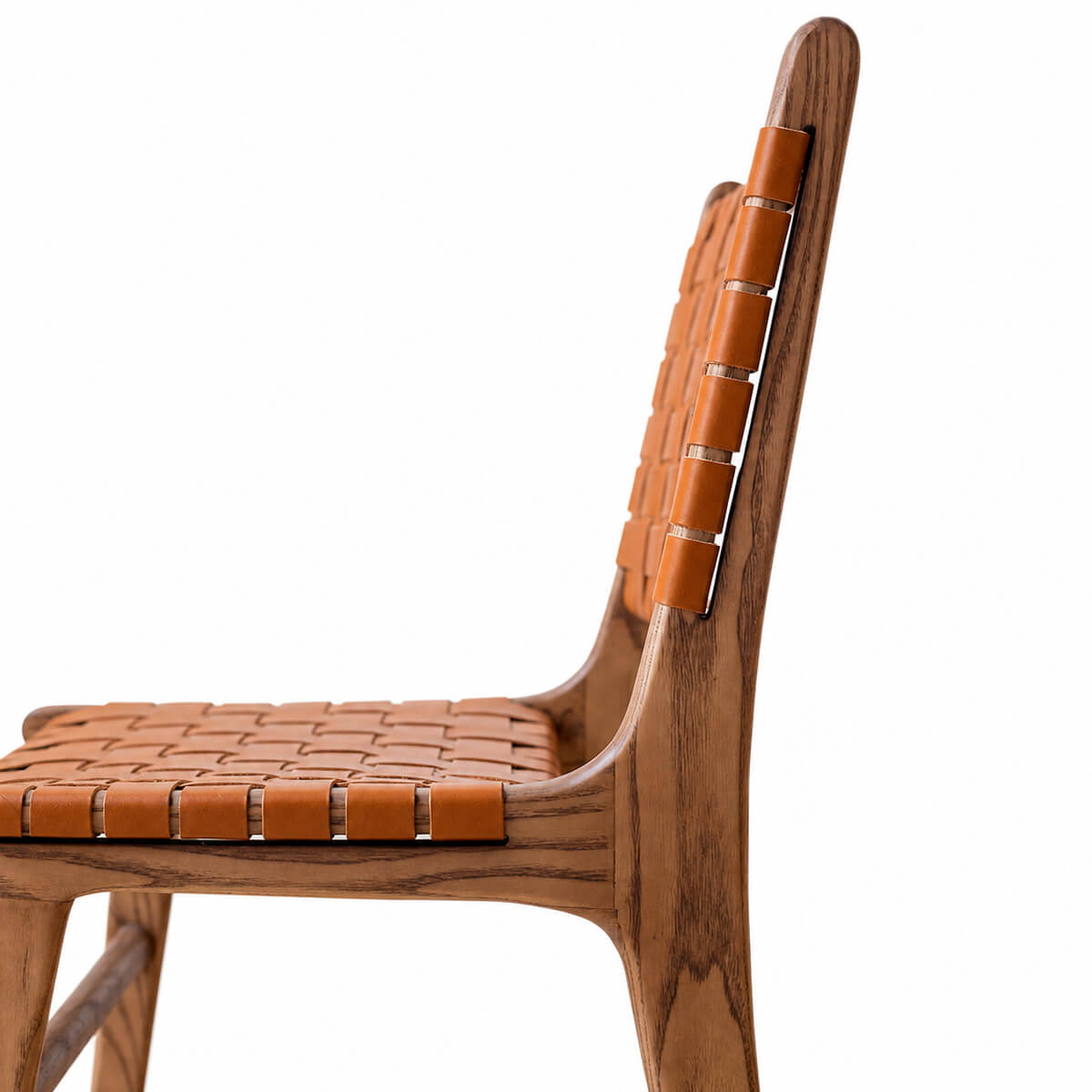 Connar dining chair side profile with woven saddle leather seat and backrest