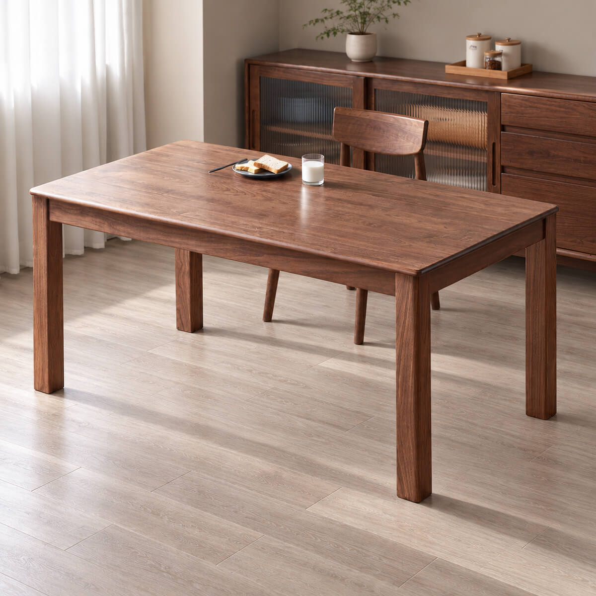Dalton solid walnut dining table styled in a contemporary dining room with warm timber furniture and natural light
