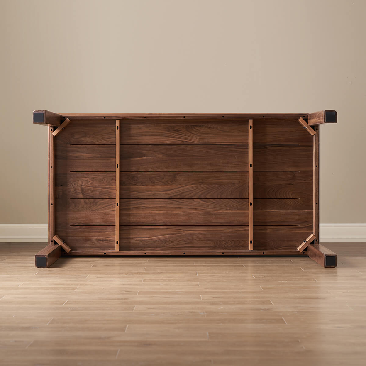 Underside view of Dalton solid walnut dining table showing timber support structure and leg construction