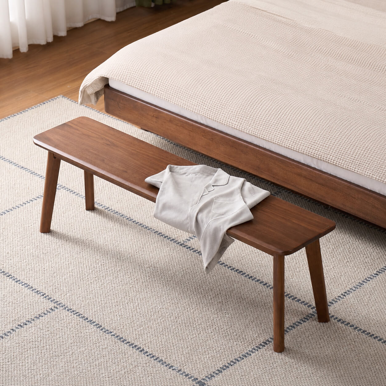 Denmark solid walnut bench positioned at the end of a bed