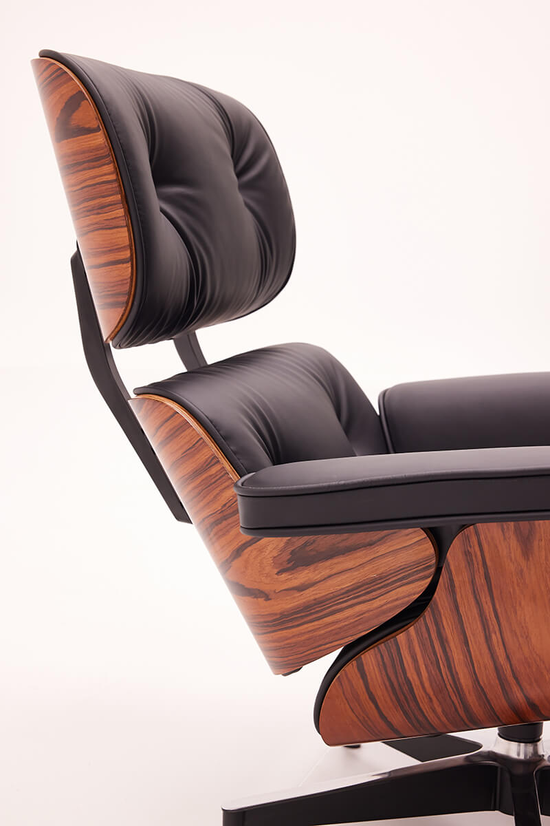 Side profile of Eames lounge chair replica with walnut veneer shell