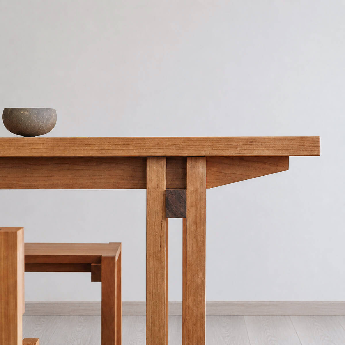 Close-up of the Edge Solid Cherry Dining Table apron and leg joinery