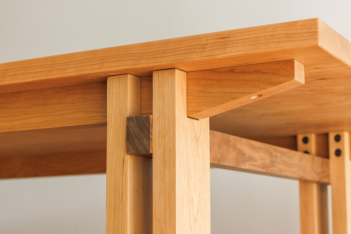 Close-up of the mortise and tenon joinery on the Edge Solid Cherry Dining Table