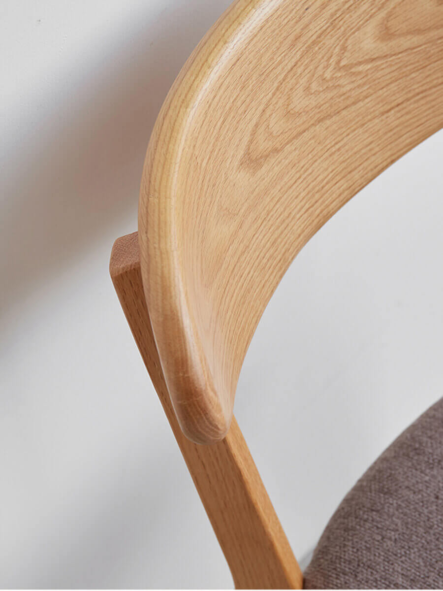 Curved timber backrest detail of Edon dining chair