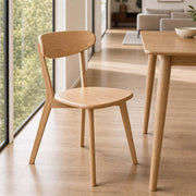 Edon dining chair in solid oak beside timber dining table