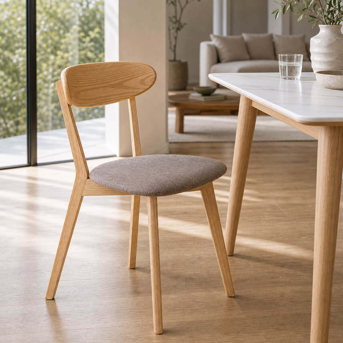 Edon dining chair with upholstered seat beside timber dining table