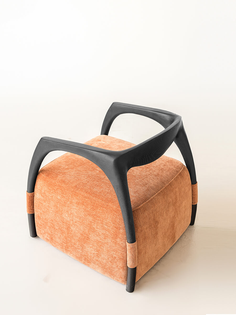 Back view of the Eland Armchair showcasing its distinctive ash wood design