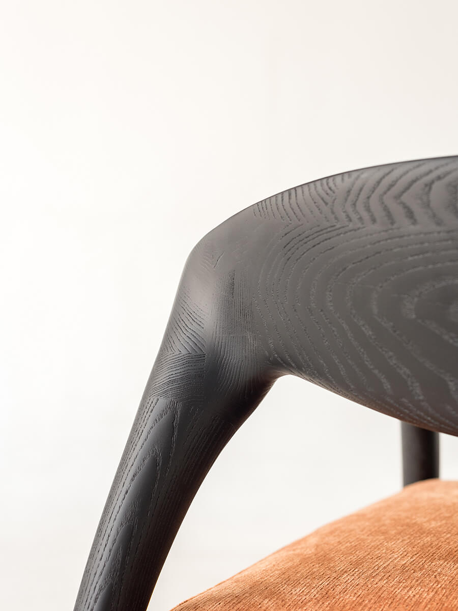Close-up detail of the Eland Armchair sculptural ash wood frame