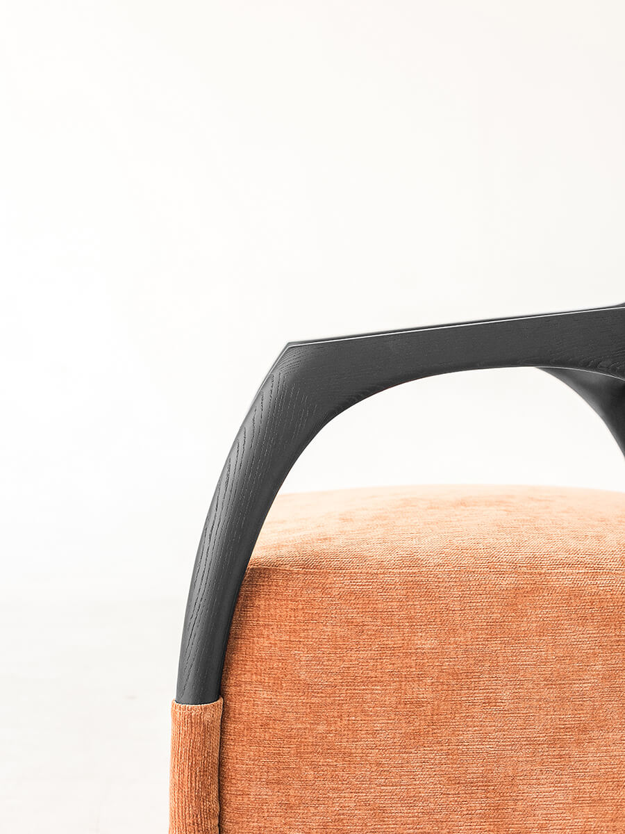 Close-up of the Eland Armchair showing the natural grain of the ash wood frame
