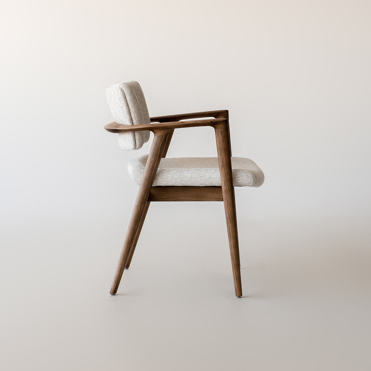 Emerson dining chair side profile showing curved timber arms and upholstered seat