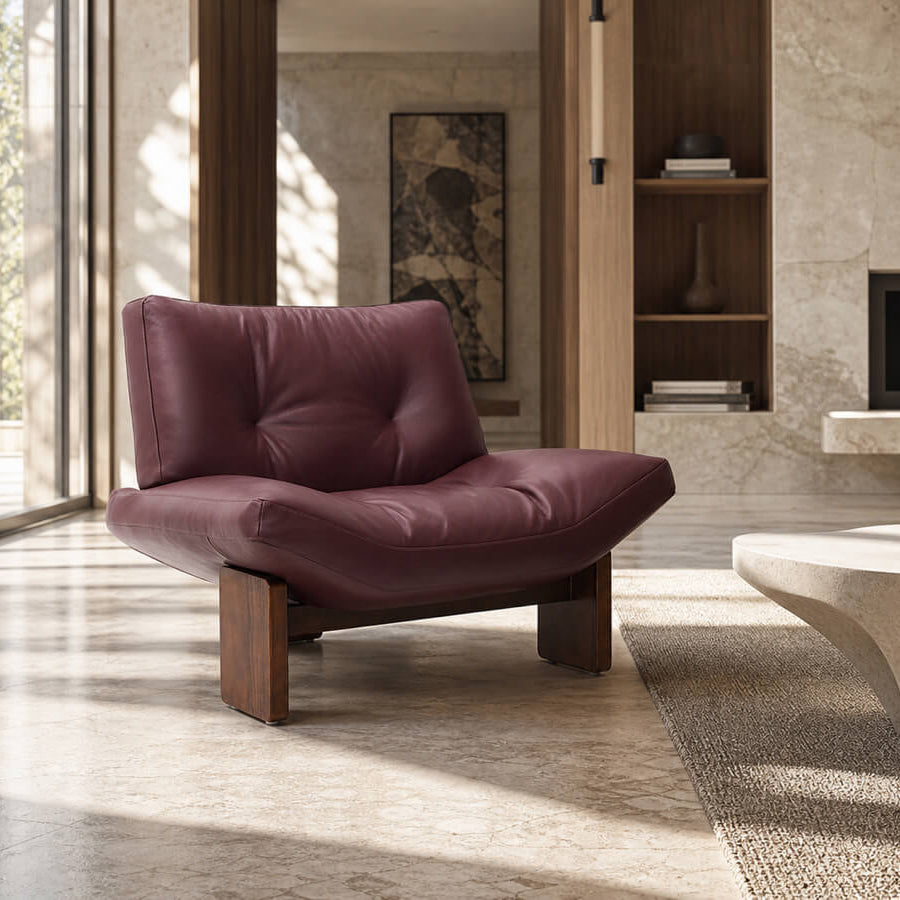 Emmi Armchair Replica upholstered in full grain leather with sculptural timber base