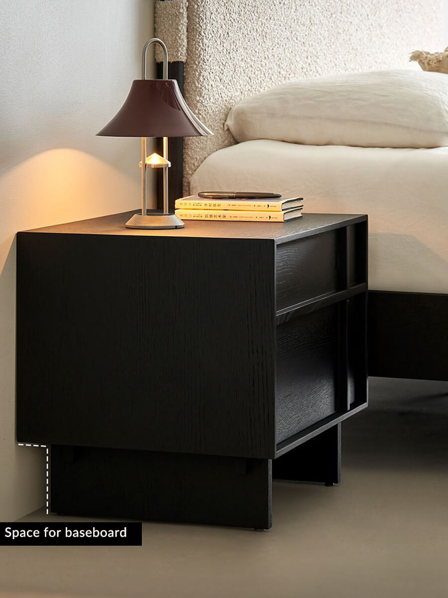 field black bedside table beside a modern bed