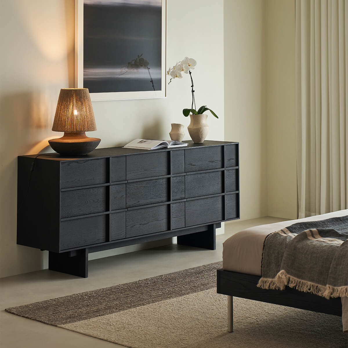 Field Chest of 9 Drawers in black finish styled in a modern bedroom