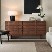 Field Chest of 9 Drawers in walnut finish styled in a contemporary living room