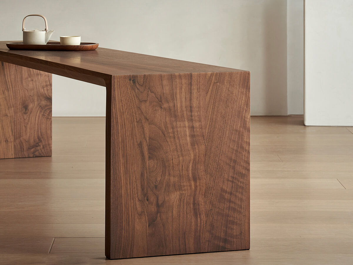 Side view of the Flemington solid walnut bench showing seamless construction