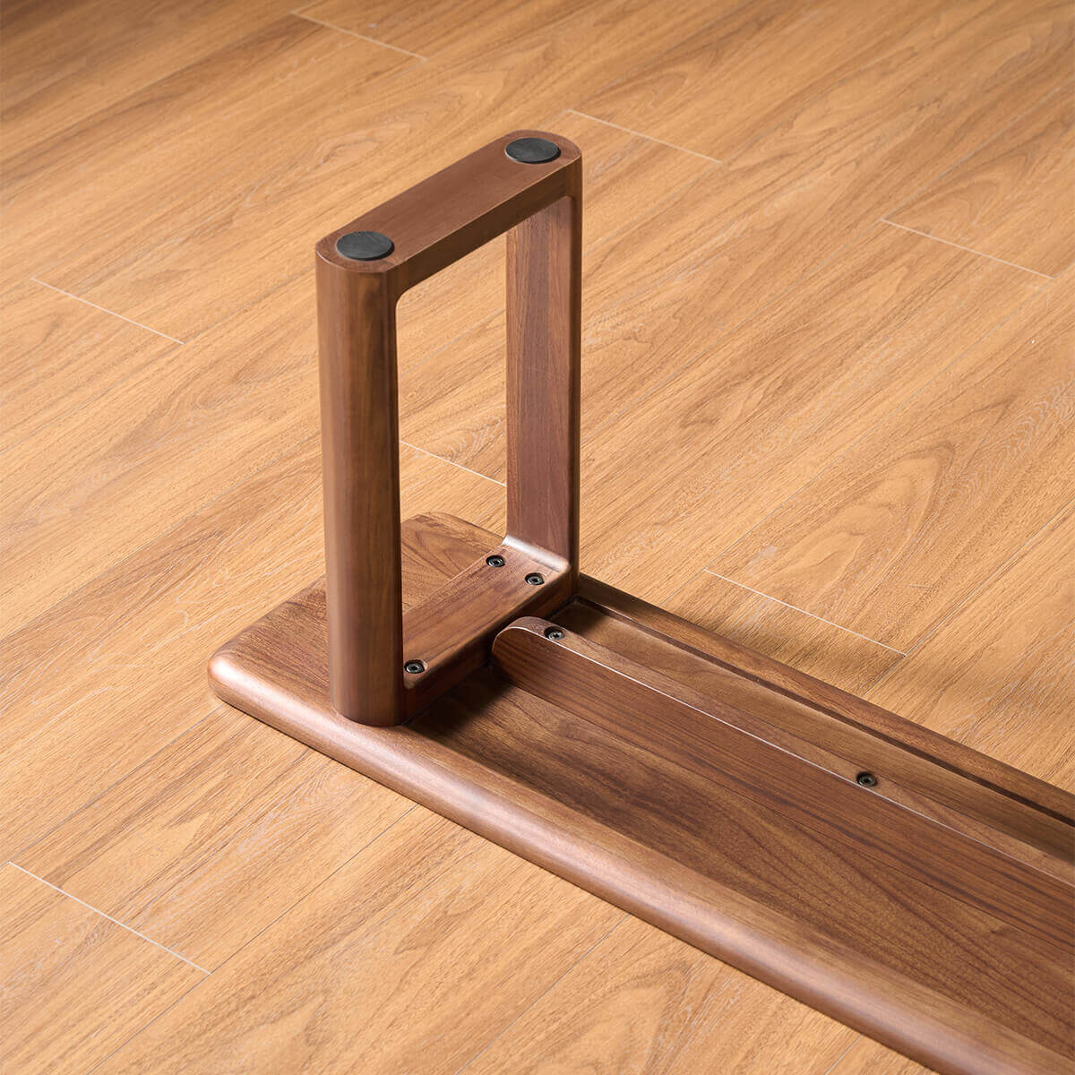 Solid walnut leg construction of the Forma Dining Bench