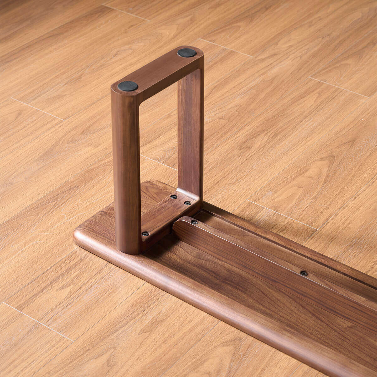 Solid walnut leg construction of the Forma Dining Bench