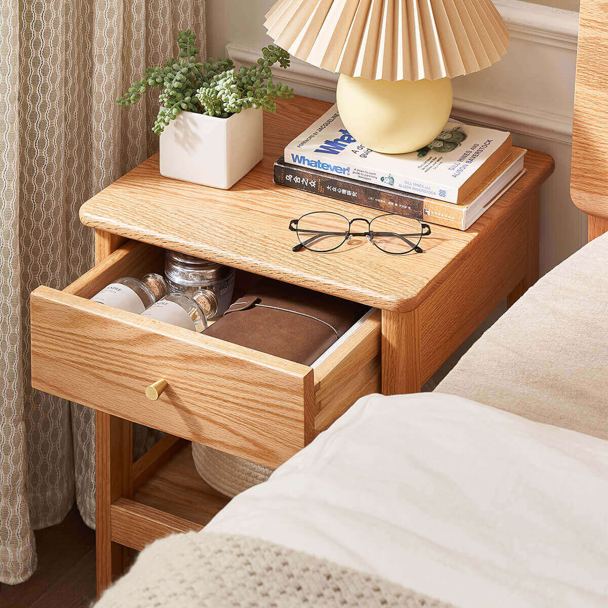 Gamo solid oak bedside table with drawer opened to show storage space