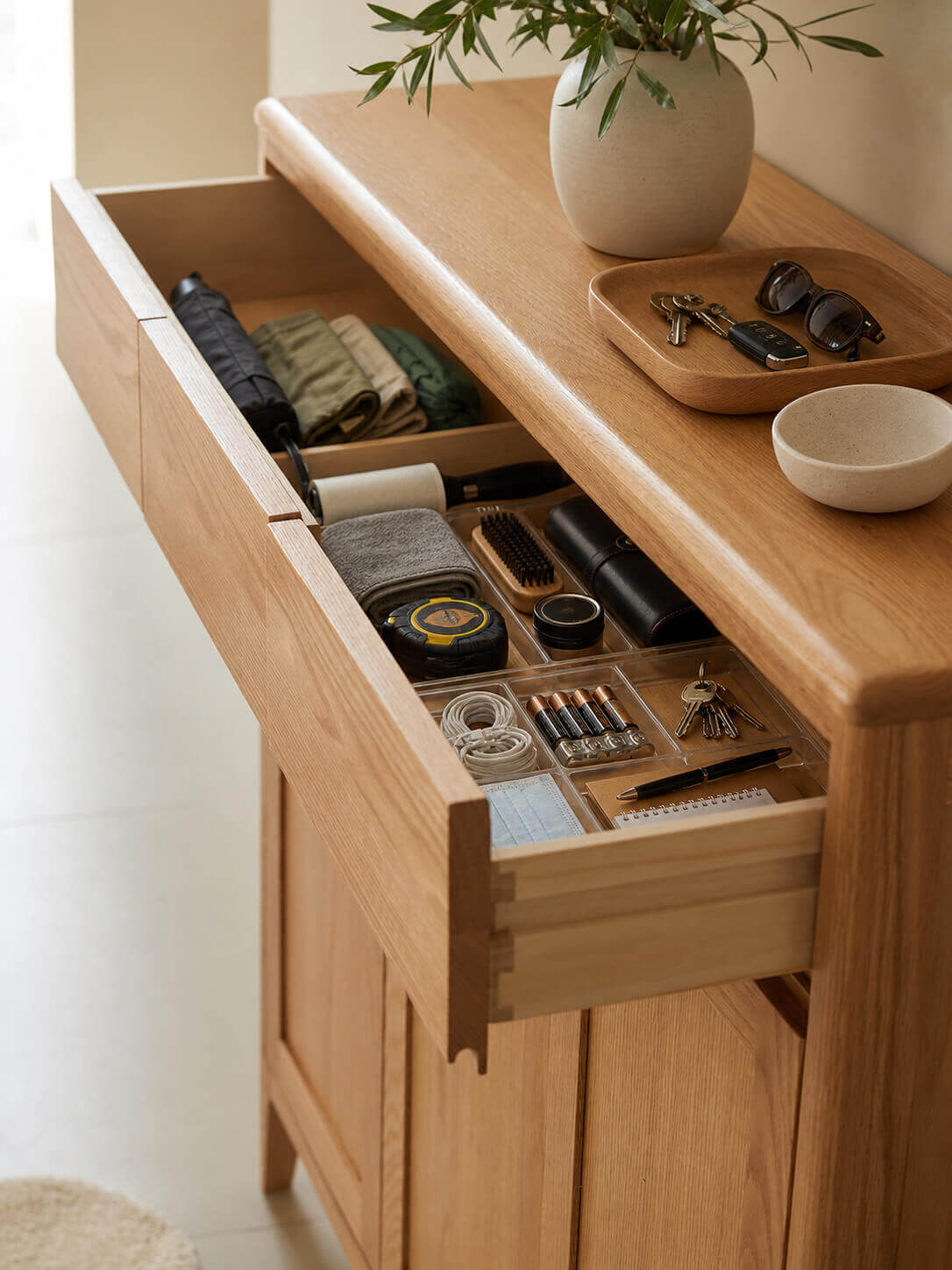 Top storage drawer of the Gamo solid oak shoe cabinet with everyday essentials