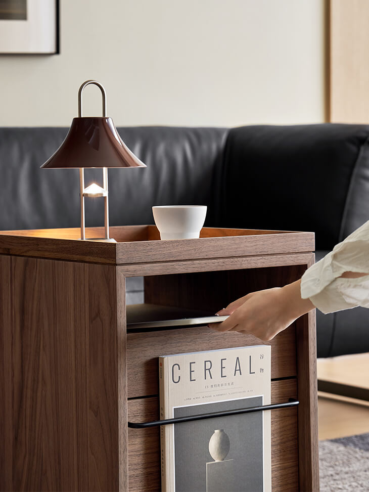 Front magazine rack and open shelf of the Glenn walnut storage pedestal