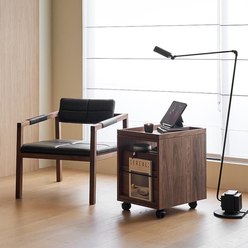 Glenn walnut storage pedestal in a contemporary reading corner