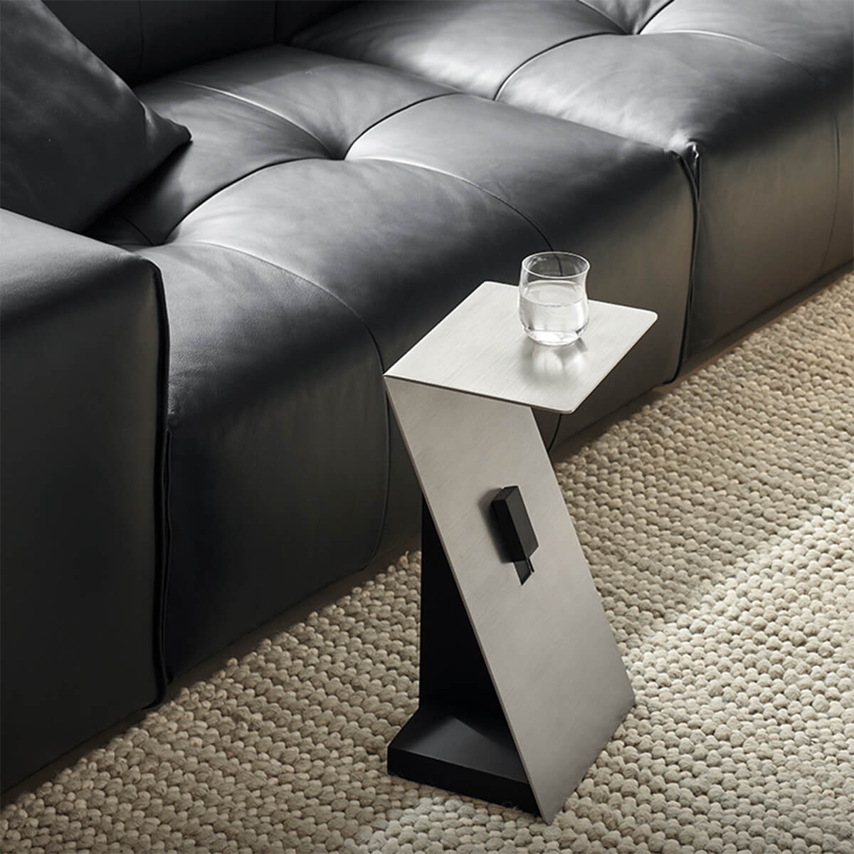 Graham side table beside a contemporary leather sofa with a phone and glass.