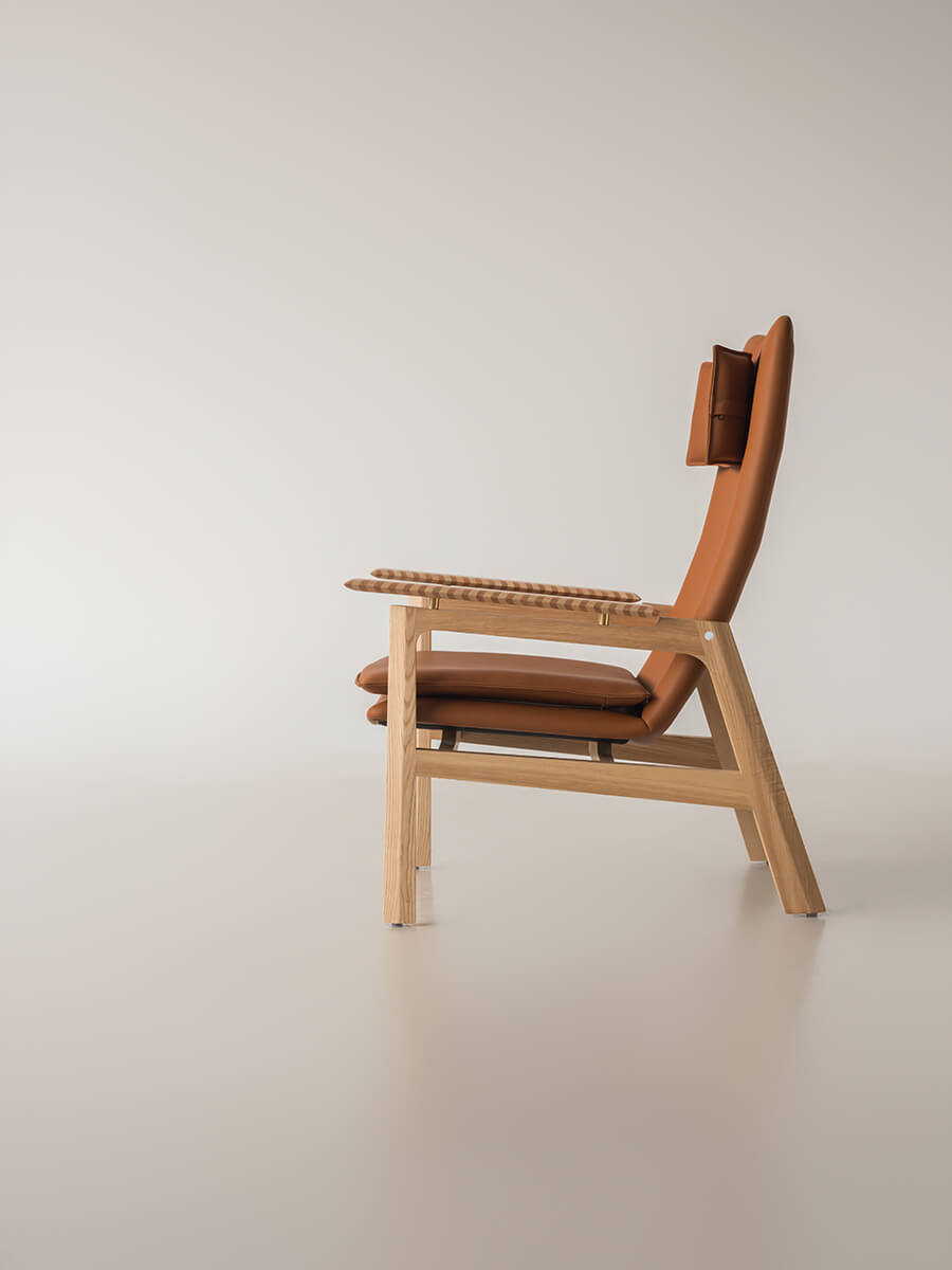 Side view of the Grant leather armchair with supportive high backrest