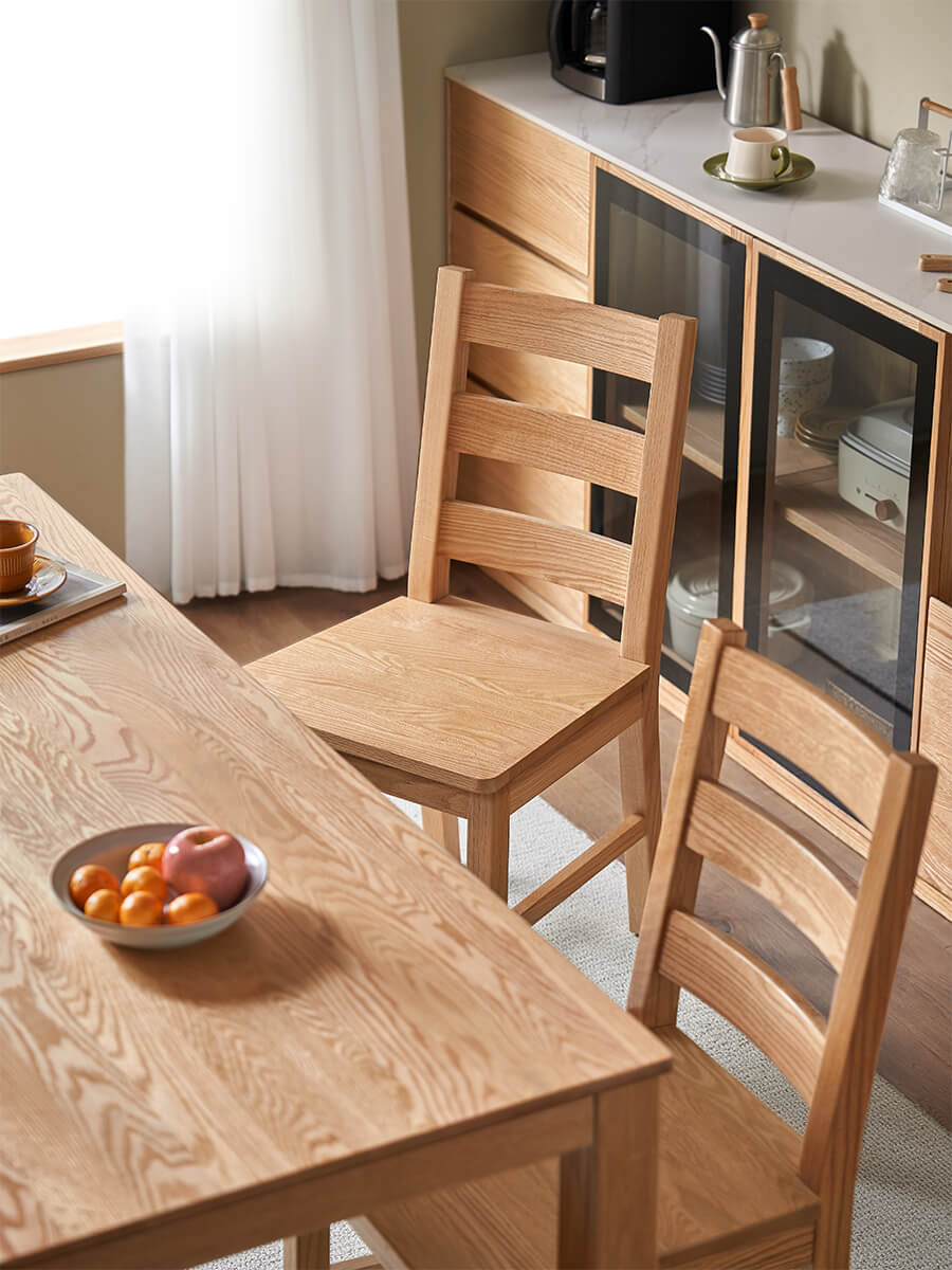 Top view of the Grant solid oak dining chair beside a solid oak dining table