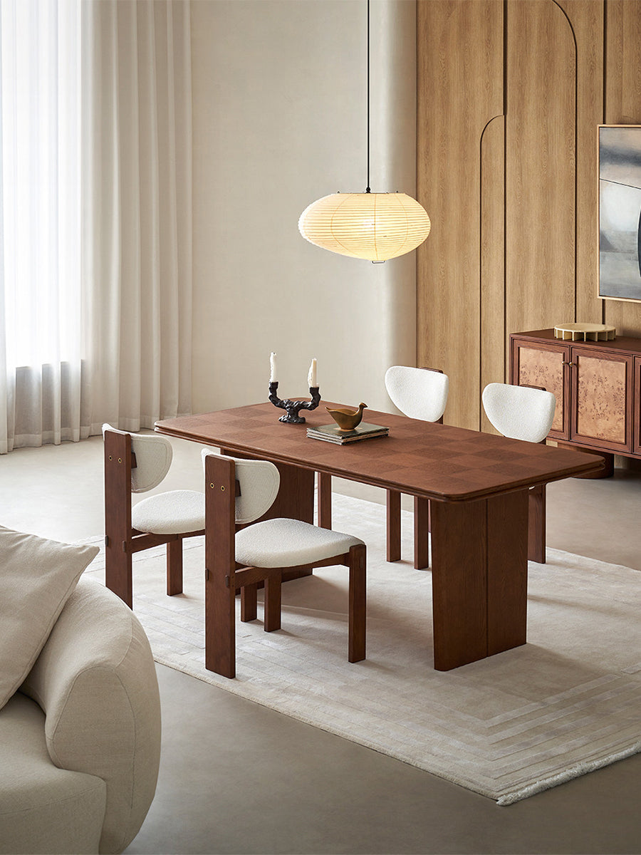 Grid dining table with checkerboard tabletop in modern interior setting