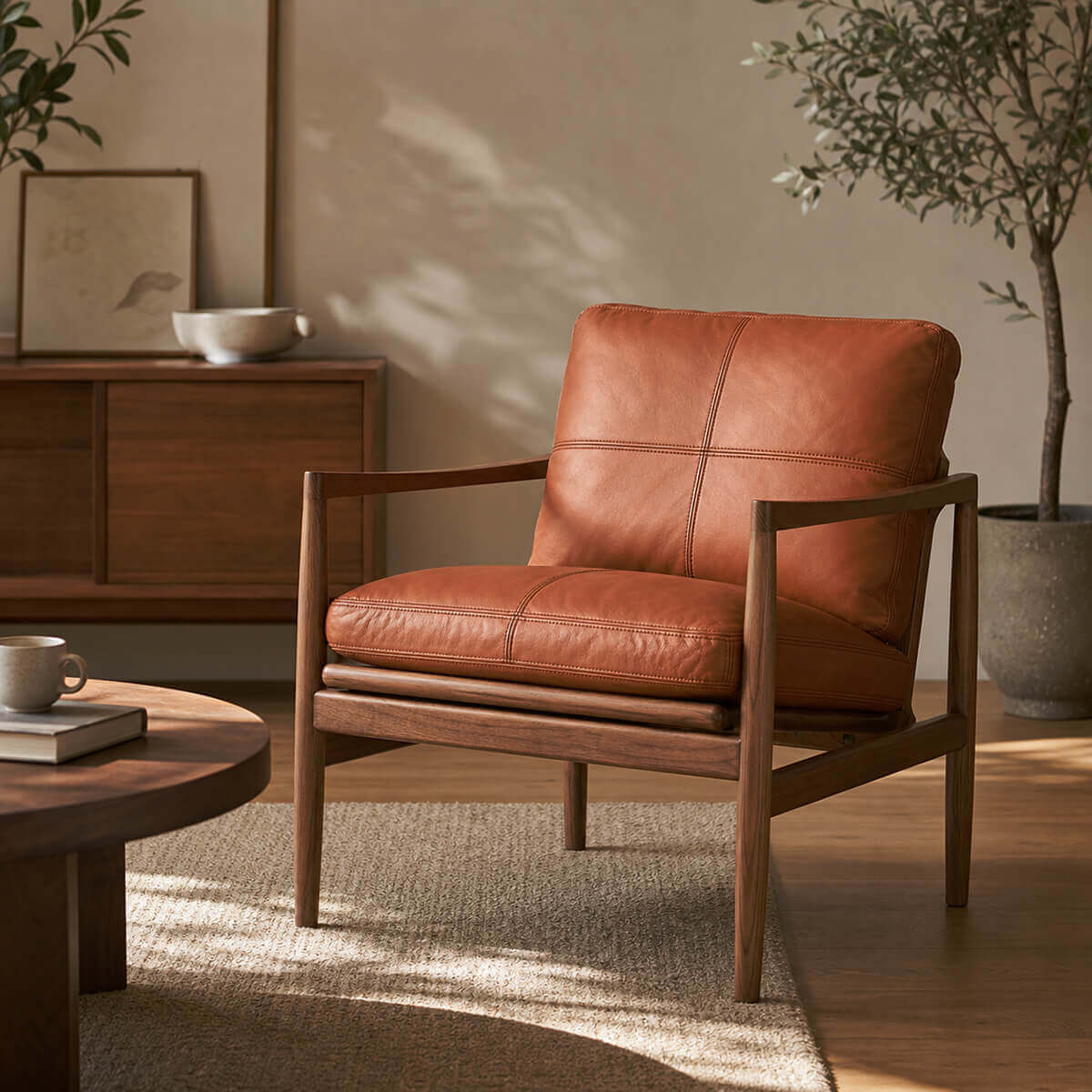 Hank armchair with caramel leather upholstery in a Scandinavian living room