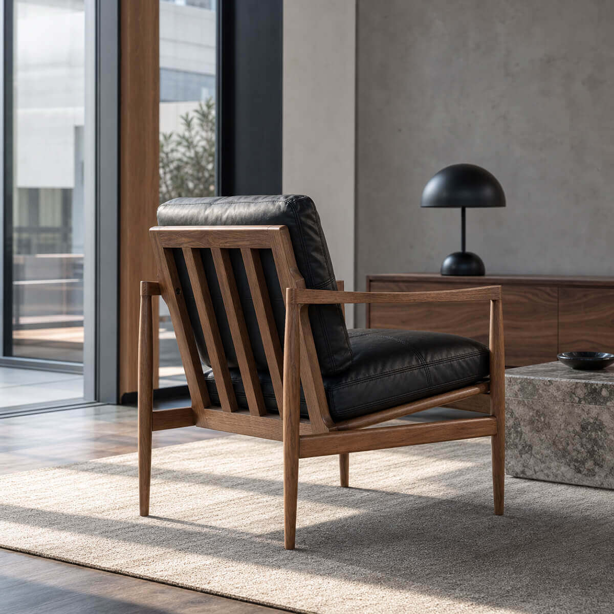 Rear view of Hank armchair with black leather upholstery